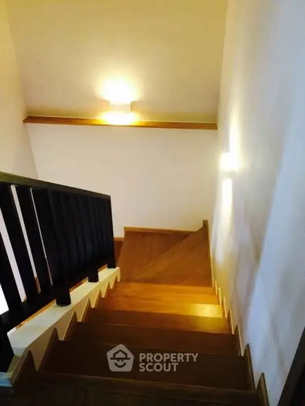Elegant wooden staircase with modern lighting in a stylish home interior