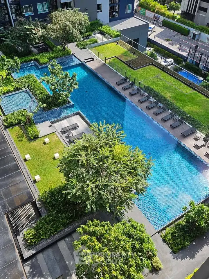 Luxurious residential complex with stunning pool and lush greenery
