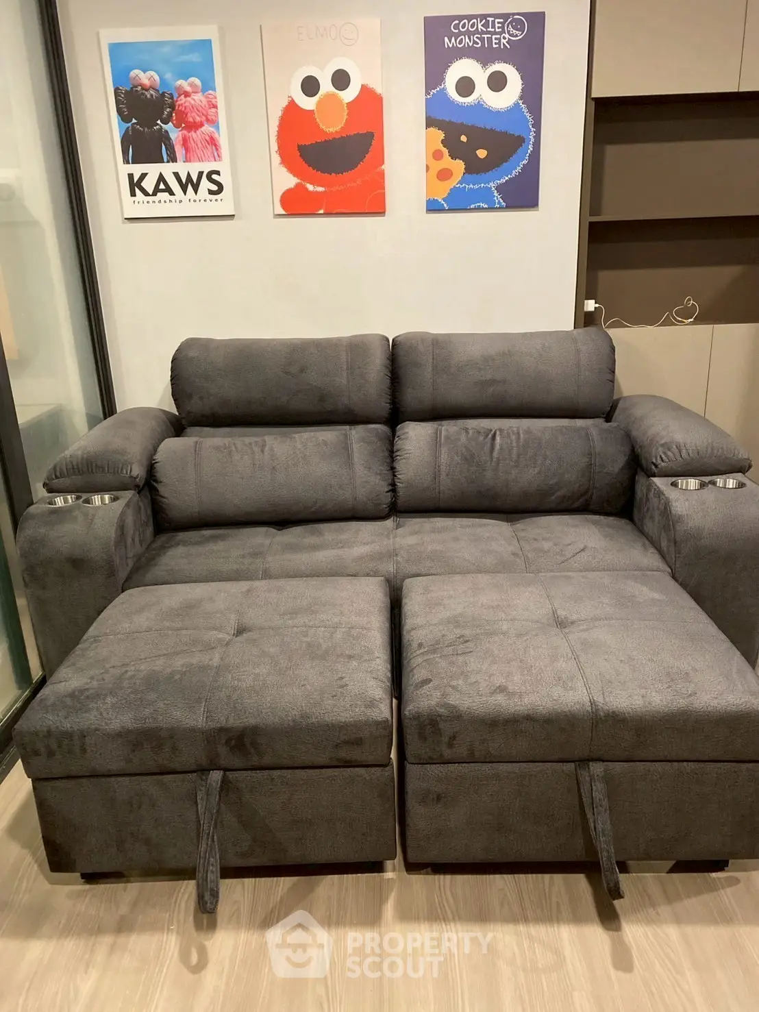 Modern living room with plush gray sofa and playful wall art