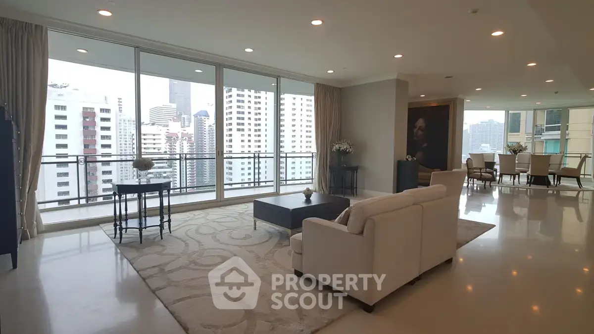 Spacious modern living room with city view and elegant decor in high-rise apartment.
