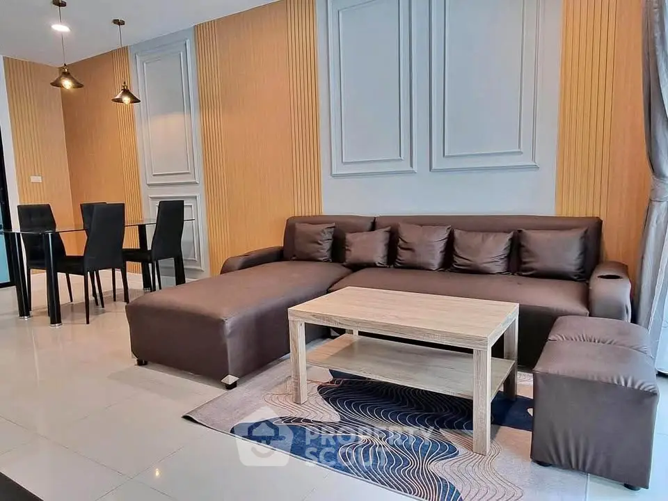 Modern living room with stylish brown sectional sofa and elegant dining area