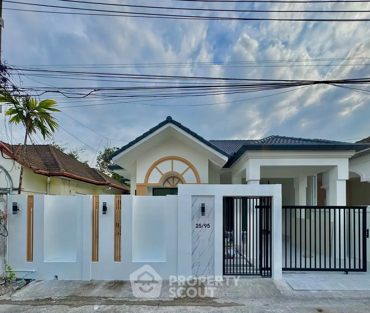 Charming suburban house with modern gate and driveway, perfect for family living.