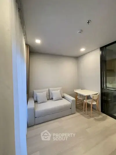 Modern minimalist living room with cozy sofa and dining area