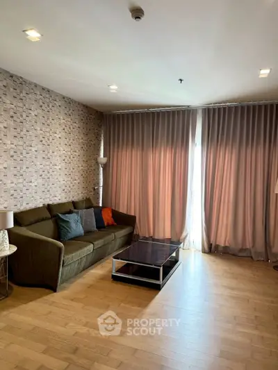 Spacious living room with modern decor and large windows for natural light.