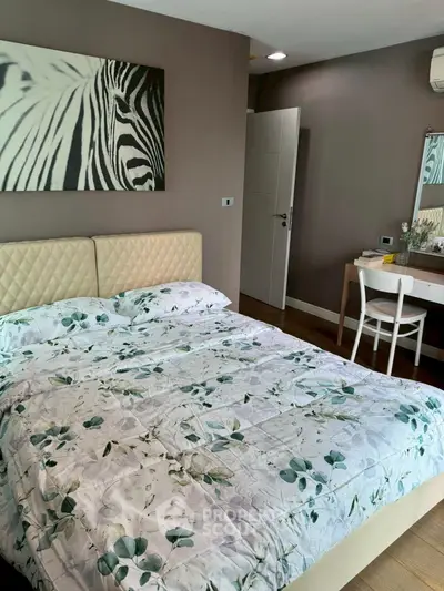 Cozy bedroom with stylish decor and comfortable bedding in modern apartment.