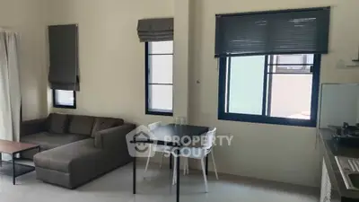 Modern living room with cozy sofa and dining area in open layout apartment