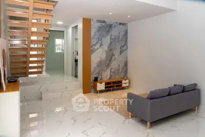 Modern living room with stylish staircase and marble flooring