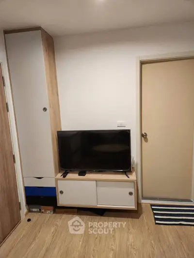 Modern living room with sleek TV stand and wooden flooring