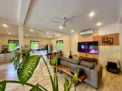 Spacious open-plan living room with modern kitchen and stylish decor