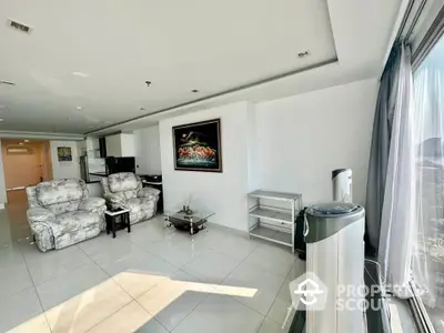 Spacious living room with modern decor and large windows offering natural light.