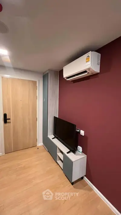 Modern living room with air conditioning and sleek TV setup