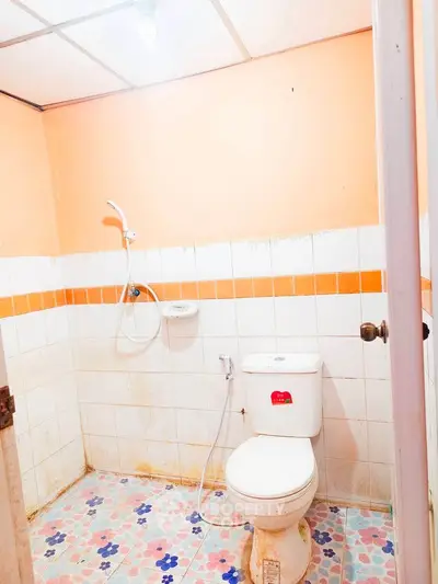 Cozy bathroom with vibrant tiles and shower in a compact space.