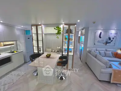 Modern open-plan kitchen and living room with stylish decor and sleek finishes.