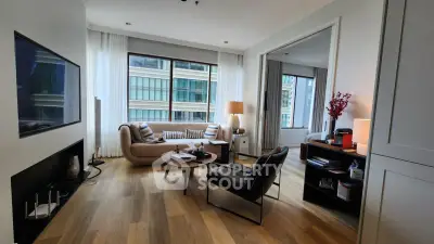 Modern living room with elegant decor and large windows in a high-rise apartment.