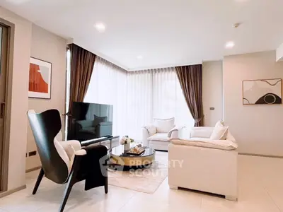 Elegant living room with modern furniture and large windows for natural light.