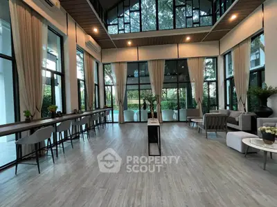 Spacious modern living room with large windows and elegant decor