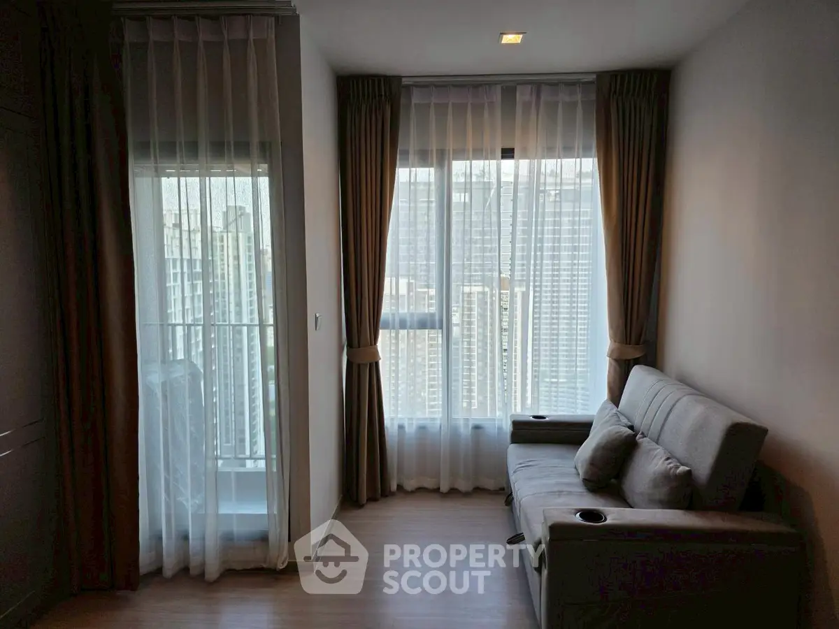 Cozy living room with city view and modern sofa, perfect for relaxation.