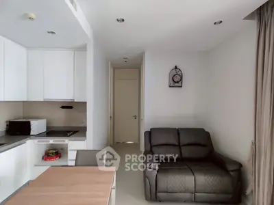 Modern apartment interior with cozy living room and sleek kitchen design.