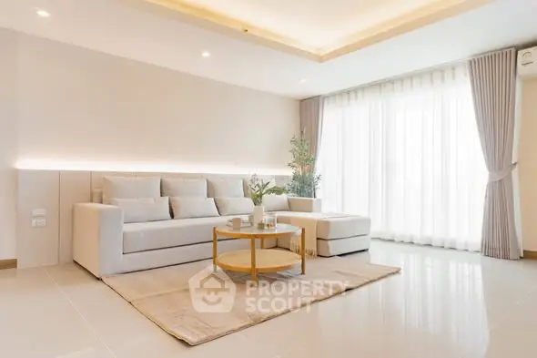 Spacious modern living room with elegant sofa and natural light