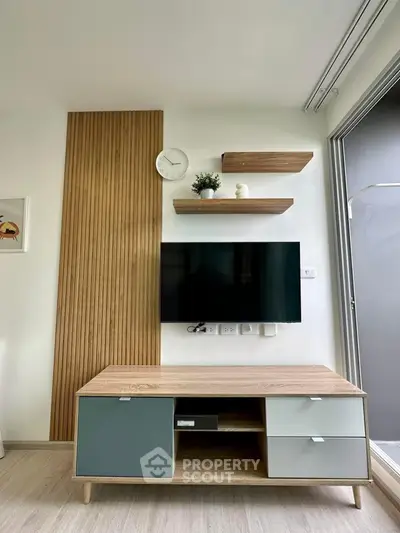 Modern living room with stylish TV setup and wooden accents