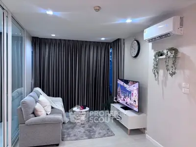 Modern living room with cozy sofa, wall-mounted TV, and elegant decor