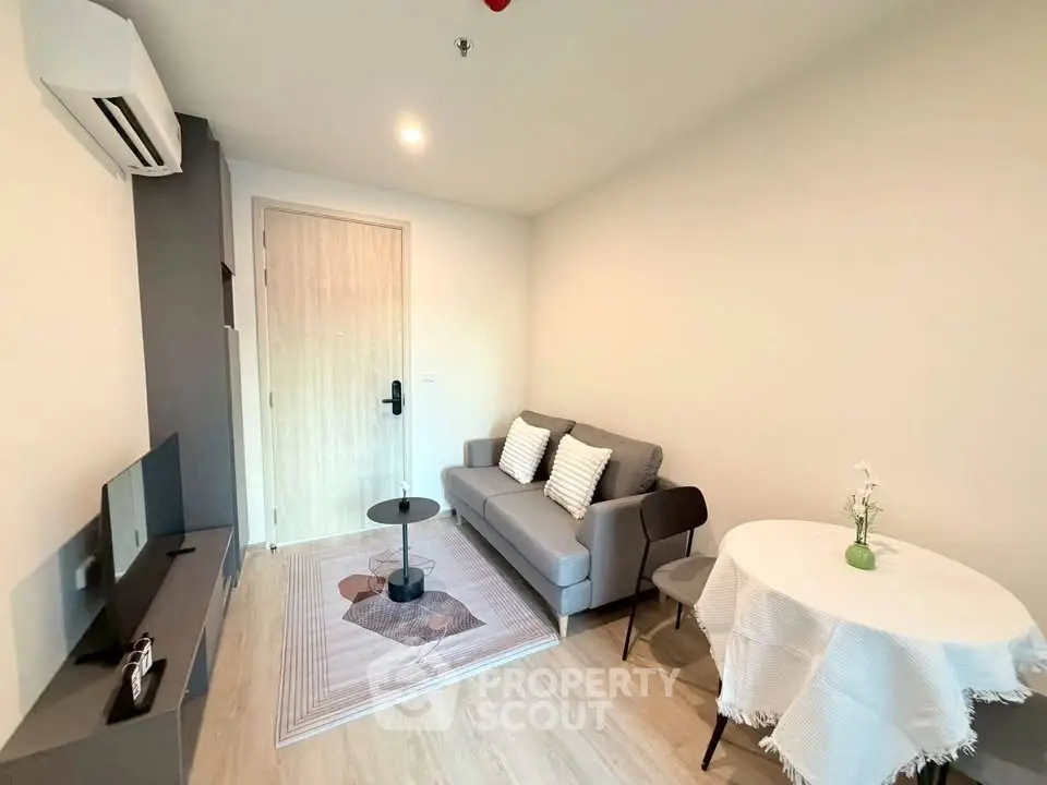 Modern living room with cozy sofa, TV, and dining table in a stylish apartment.