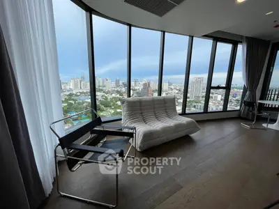 Luxurious high-rise living room with panoramic city views and modern furniture.