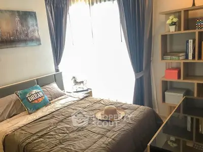 Cozy bedroom with stylish decor and ample natural light, featuring a comfortable bed and modern shelving.