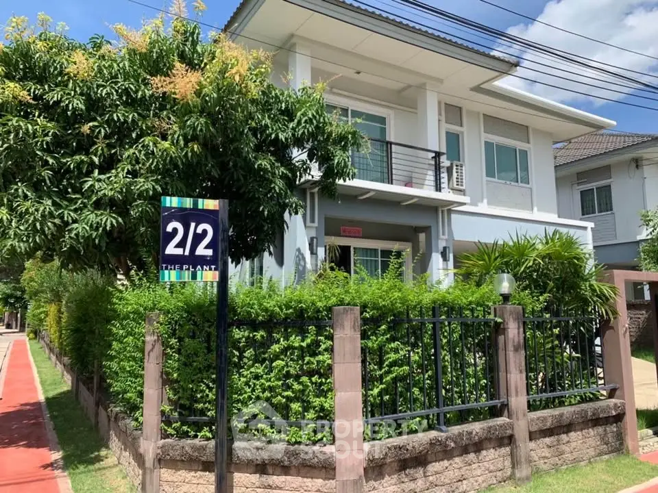 Charming two-story house with lush garden and modern design in a serene neighborhood.