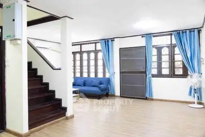 Spacious living room with modern decor and large windows for natural light.