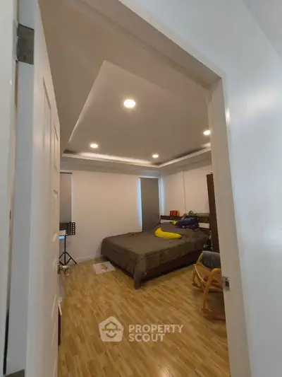 Cozy bedroom with modern lighting and wooden flooring