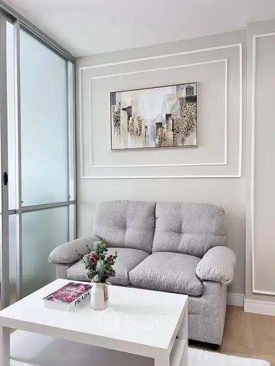 Cozy living room with modern decor and plush gray sofa
