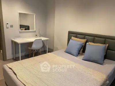 Modern bedroom with stylish decor and cozy ambiance, featuring a comfortable bed and sleek desk area.