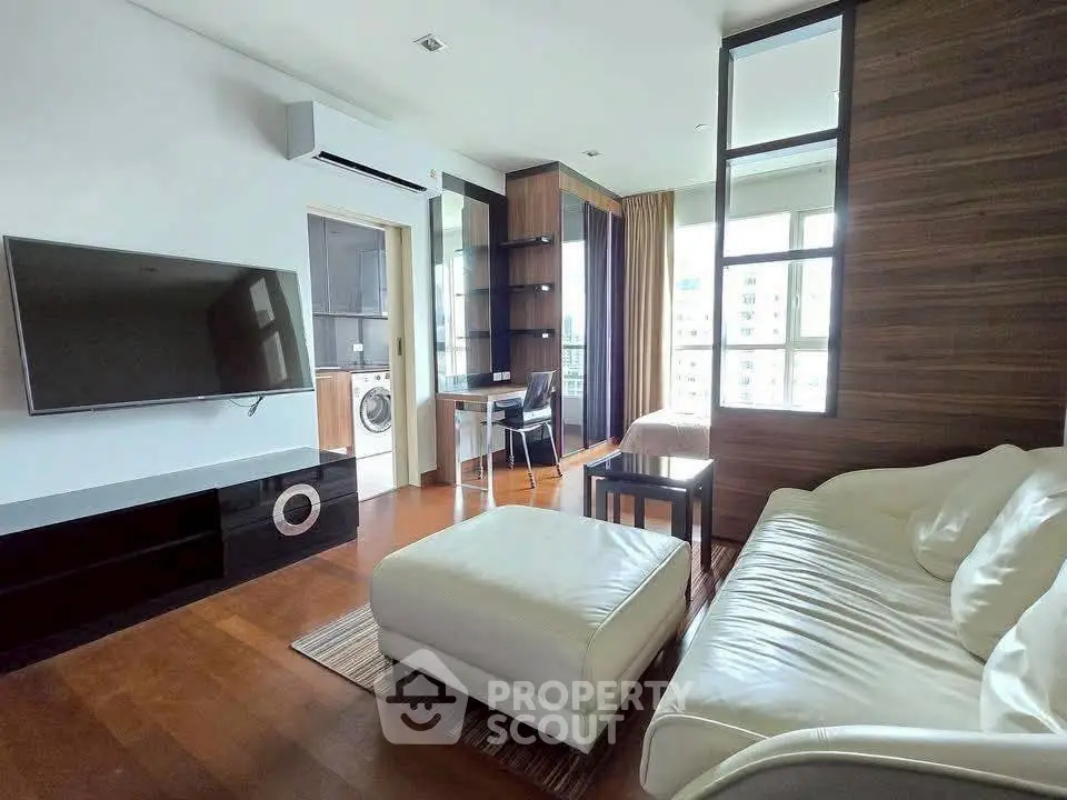 Stylish living room with modern decor and large windows offering city views.