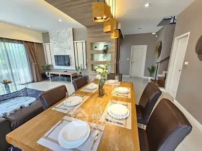 Luxurious open-plan living and dining area with modern decor and ample natural light.