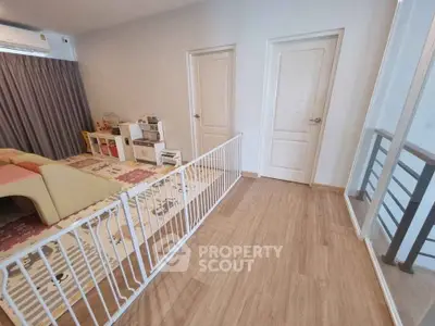 Spacious living area with child-friendly play zone and safety gate