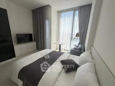 Luxurious bedroom with modern decor and floor-to-ceiling windows offering stunning city views.