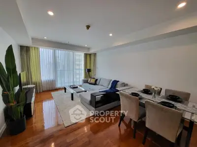 Spacious modern living room with elegant dining area and large windows.