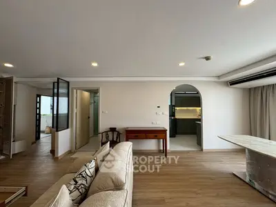Spacious living room with modern open layout and elegant wooden flooring