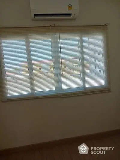 Bright room with window blinds and air conditioning, perfect for comfortable living.