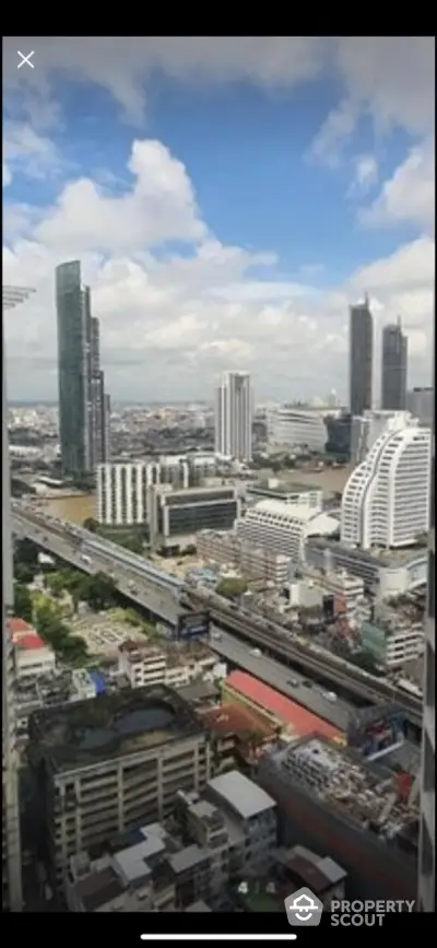 Stunning cityscape view from a high-rise building showcasing urban architecture and skyline.