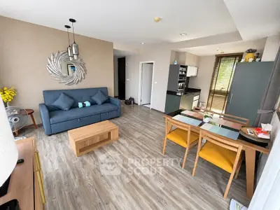 Modern open-plan living room with stylish decor and kitchen area