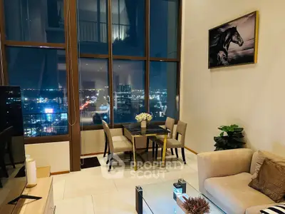 Luxurious high-rise living room with stunning city view, elegant decor, and floor-to-ceiling windows.