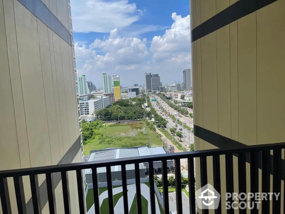 Stunning cityscape view from high-rise balcony with clear blue sky