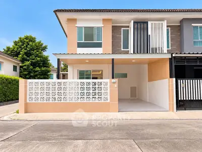Modern two-story townhouse with stylish facade and spacious driveway in a serene neighborhood.