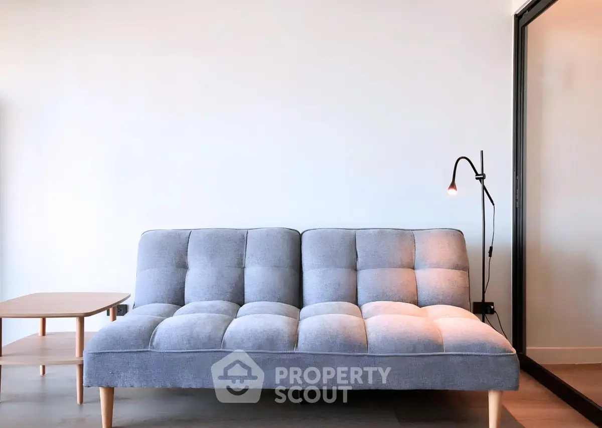 Modern minimalist living room with stylish gray sofa and sleek floor lamp