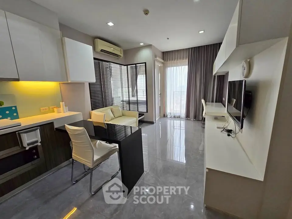 Modern living room with sleek design and open layout, featuring a cozy seating area and stylish decor.