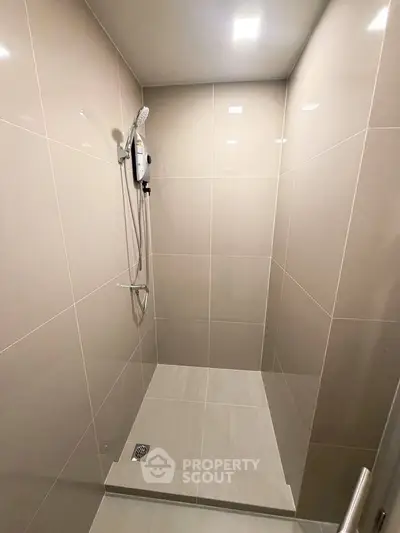 Modern bathroom with sleek shower design and neutral tiles