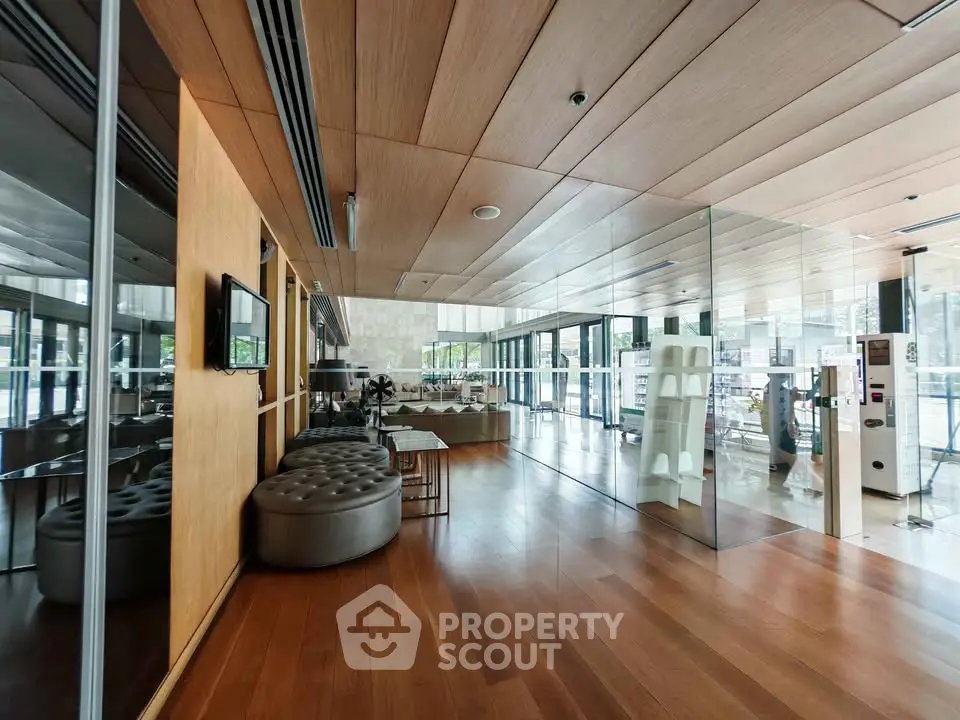 Spacious modern living room with wooden floors and glass walls