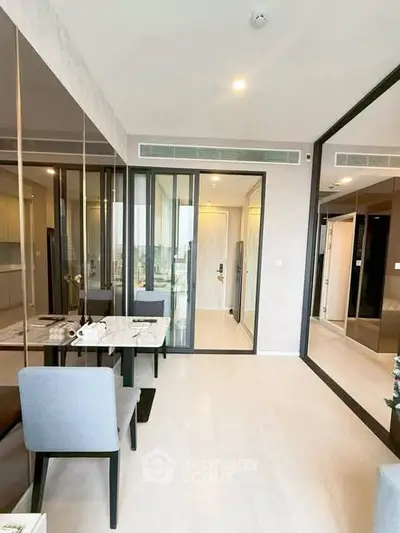 Modern living room with sleek design and large mirrors enhancing space and light.
